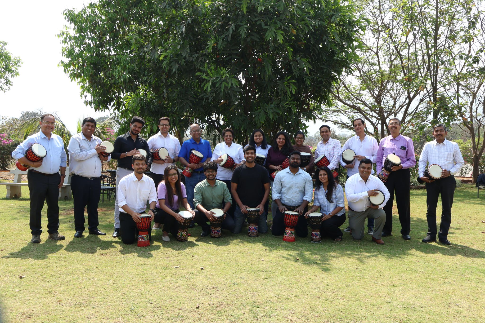 The NavAI team posing with drums during a team-building activity.