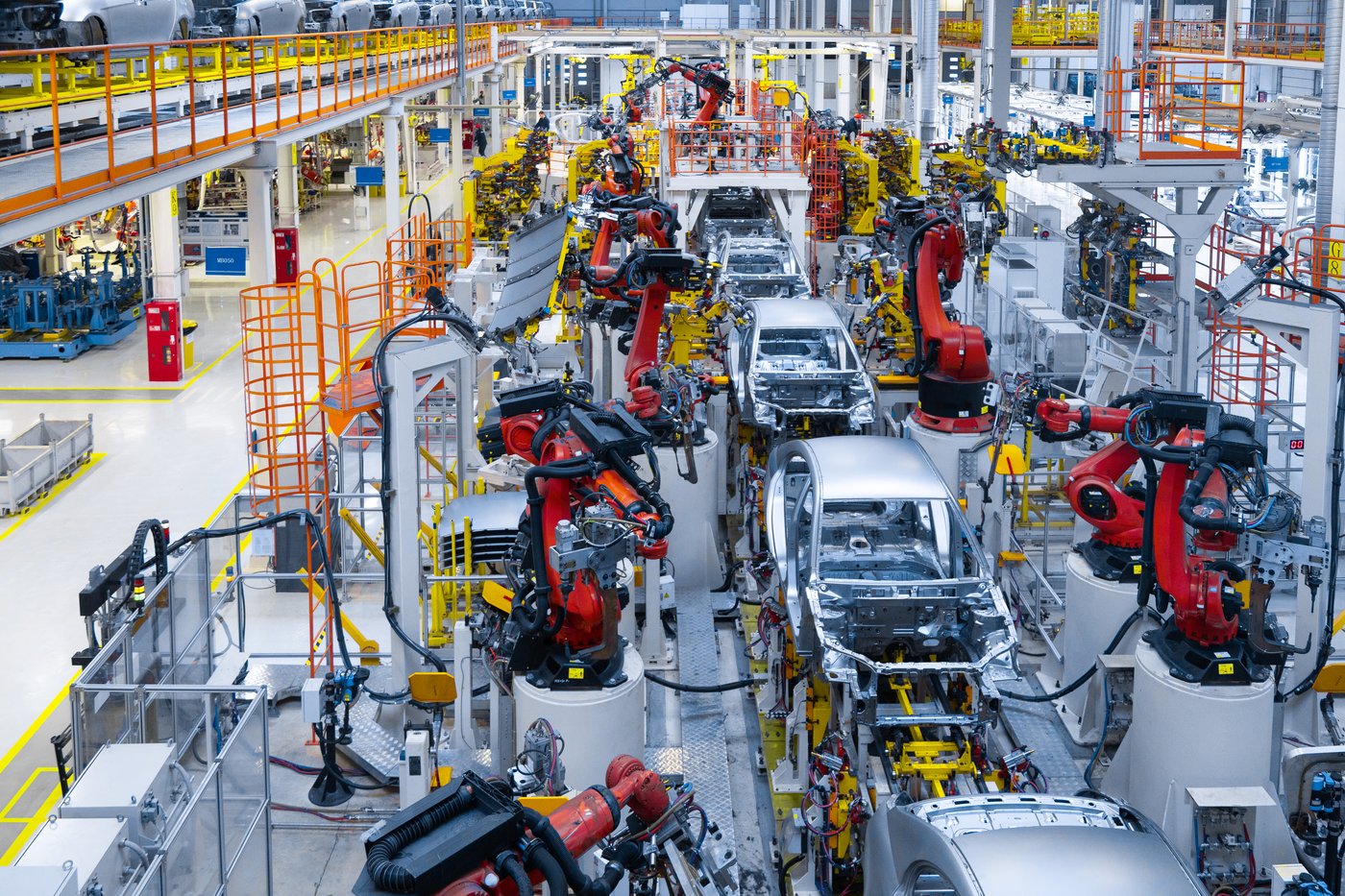 Robotic arms welding car frames on an automated assembly line