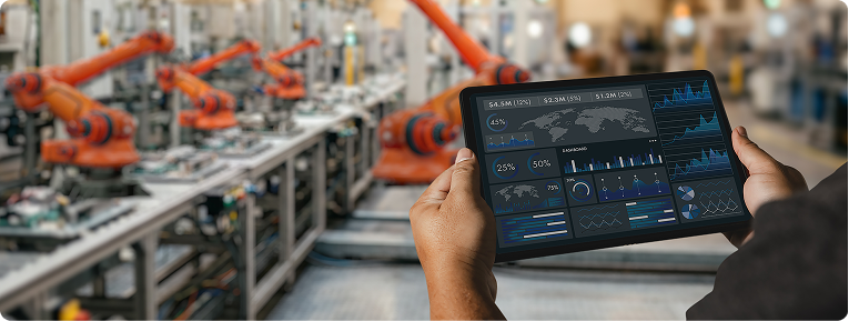 An engineer reviewing a factory floor dashboard on a tablet